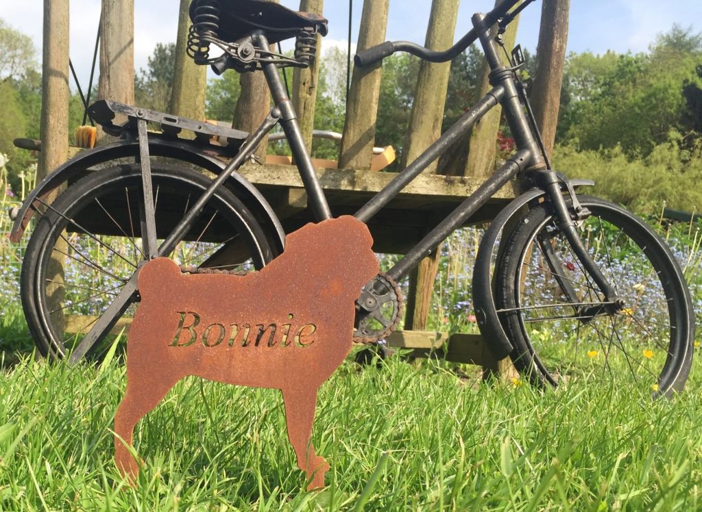 A hand-cut steel memorial marker engraved with the name Bonnie